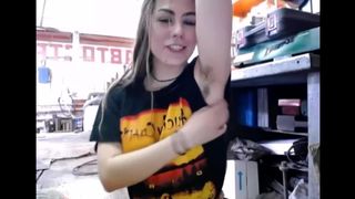 Девушка с волосатыми подмышками задирает в гараже юбку и играет с лохматкой